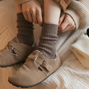 Deep brown ribbed crew socks for women made of warm wool, paired with brown loafers