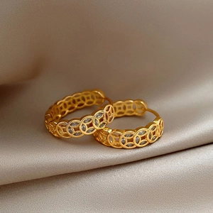 Gold plated round coin earrings with cubic zirconia on a champagne satin background