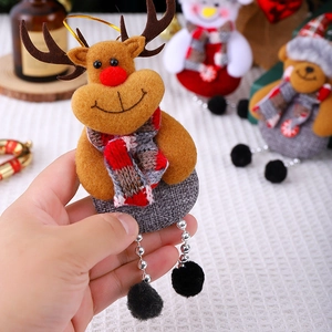 Detail of a handmade felt reindeer Christmas ornament with red nose and plaid scarf