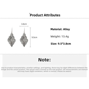 Detailed macro view of leaf-shaped layered metal earrings with alloy texture and size metrics