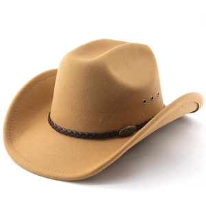 Detail of camel western cowboy hat featuring braided leather band and metal emblem accent