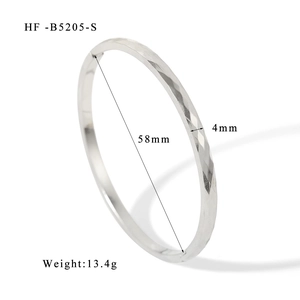 Detailed view of silver stainless steel bangle with geometric pattern and 58mm diameter size