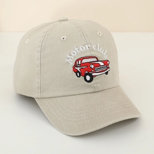 Detail of vintage red car embroidery with Motor Club text on beige cotton baseball cap