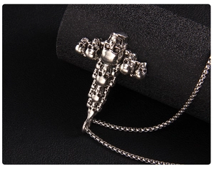 Detailed close-up of a silver punk skull cross pendant on a high-quality box chain