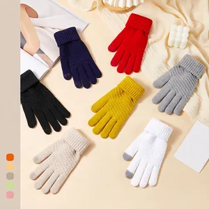 Thick knit touch screen winter gloves in seven colors with ribbed cuffs on warm background