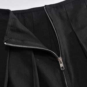 Close-up of high-quality metal zipper and black twill fabric texture on skirt set