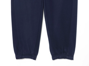 Detail of elastic cuffed ankles on navy blue knit sweatpants with high-quality texture