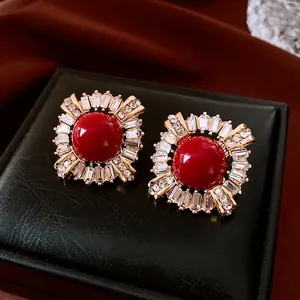 Vintage red gemstone earrings with gold frame and cubic zirconia stones in luxury case
