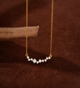 Macro detail of a 925 sterling silver smile necklace with micro-set sparkling diamonds
