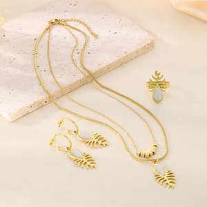 Détail du collier chaîne serpent dorée, bague feuille et boucles d'oreilles sertis d'opales