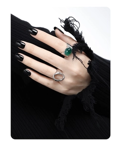 Detail of silver S925 rings featuring green agate inlay and minimalist circular design