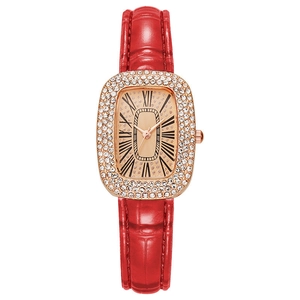 Detail of red leather strap watch with rose gold diamond case and Roman numeral dial