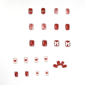 Short square press-on nails with rose red marble design and 3D bow heart accents