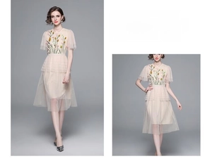 Detail of mesh tulle dress with floral embroidery and tiered layered cake skirt
