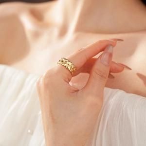 Close-up of 18k gold plated heart ring worn on finger with rich metallic luster