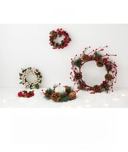 Detailed set of Christmas berry wreaths and candle rings with pine cones for festive decor