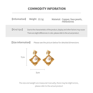 Detailed view of gold geometric wave earrings with pearls, rhinestones and specifications