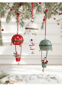 Detail of Christmas hot air balloon metal pendants with Santa, snowman and elk hanging on pine