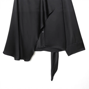 Elegant black satin cape top with glossy finish, button detail and adjustable tie hem