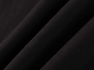 Detailed close-up of high-quality black ribbed cotton fabric showing fine knit texture