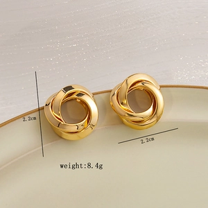 Detail showing intertwined gold geometric hoop earrings with 2.2cm size and 8.4g weight