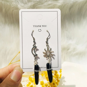 Detail of sun and moon stainless steel earrings with handmade crystal wire wrapping