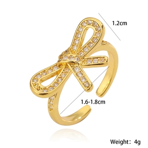 Exquisite 18K gold plated bow ring with sparkling cubic zirconia on a white background