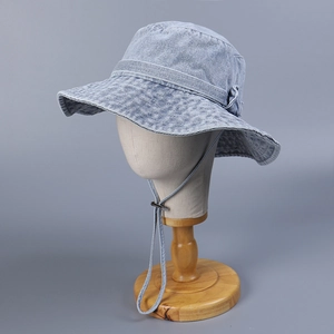 Detail of light blue denim sun hat with wide brim and adjustable windproof drawstring