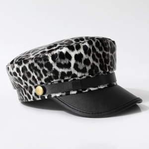 Leopard print baker boy hat with black visor and gold metal button decoration