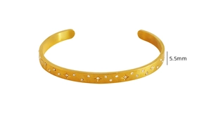 Detail view of 18K gold plated steel cuff with star-engraved zircon stones and 5.5mm width