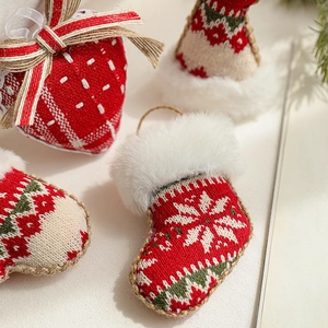 Knitted Christmas ornaments featuring socks, hats and strawberries with plush white trim