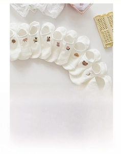 Detail of white cotton invisible boat socks with assorted cute embroidery patterns