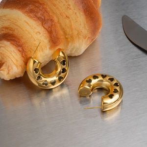Detailed view of gold-plated stainless steel C-hoop earrings with hollow heart design.