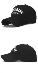 Detailed close-up of white 3D embroidery on a black cotton baseball cap showing Tenerife logo