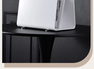 Detailed macro view of white acrylic magazine rack metal support legs on black surface