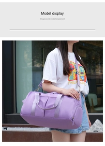 Detailed view of purple fitness bag with separate side zip pocket and adjustable strap