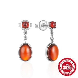 Elegant 925 sterling silver earrings with oval amber red gemstones on white background