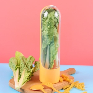 Vertical fresh herb keeper pod with transparent cover and yellow base on a wooden board