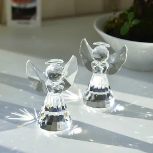 Pair of crystal angel figurines with multifaceted cut glass and rainbow light refraction