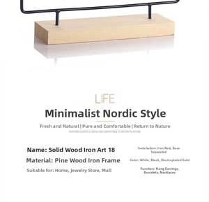 Close-up of pine wood base and iron wire hooks on the minimalist jewelry stand