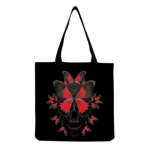 Close-up of black canvas tote featuring a creative red butterfly skull graphic print
