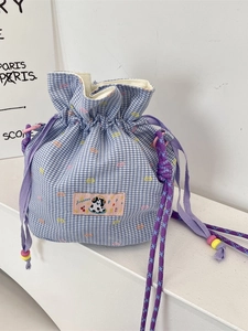 Blue gingham drawstring bucket bag with floral patterns and cartoon patch details