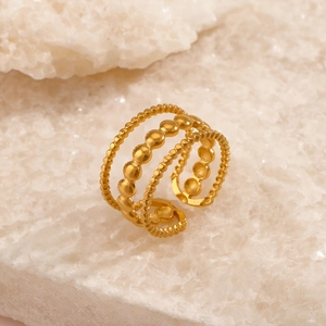 Three-layer 18K gold plated beaded stainless steel open ring on a marble stone base