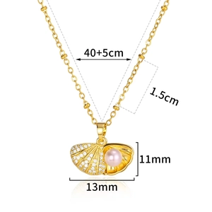 Detail of gold shell pendant with white zircon stones and pink pearl on beaded chain