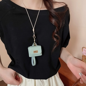 Detail of mint green leather mini croissant bag necklace with gold clasp and long lanyard