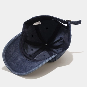 Detail view of washed cotton baseball cap interior with white label and metal buckle
