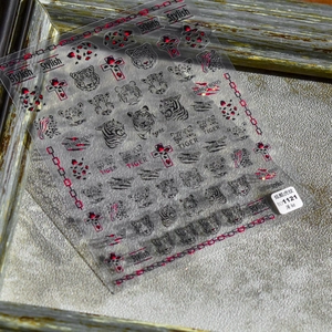 Detail showing ultra-thin tiger stripe nail decals with stylish animal motifs and patterns