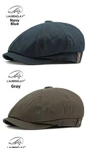 Detail of navy blue and grey cotton newsboy caps with side metal button accents