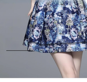 Detail of blue jacquard dress hem featuring rabbit prints and black lace trim