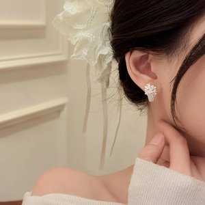 Elegant pearl flower basket stud earrings with zircon crystals shown on female ear